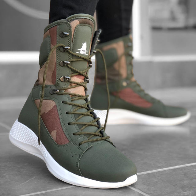 Green high-top sneakers with camouflage pattern worn indoors.